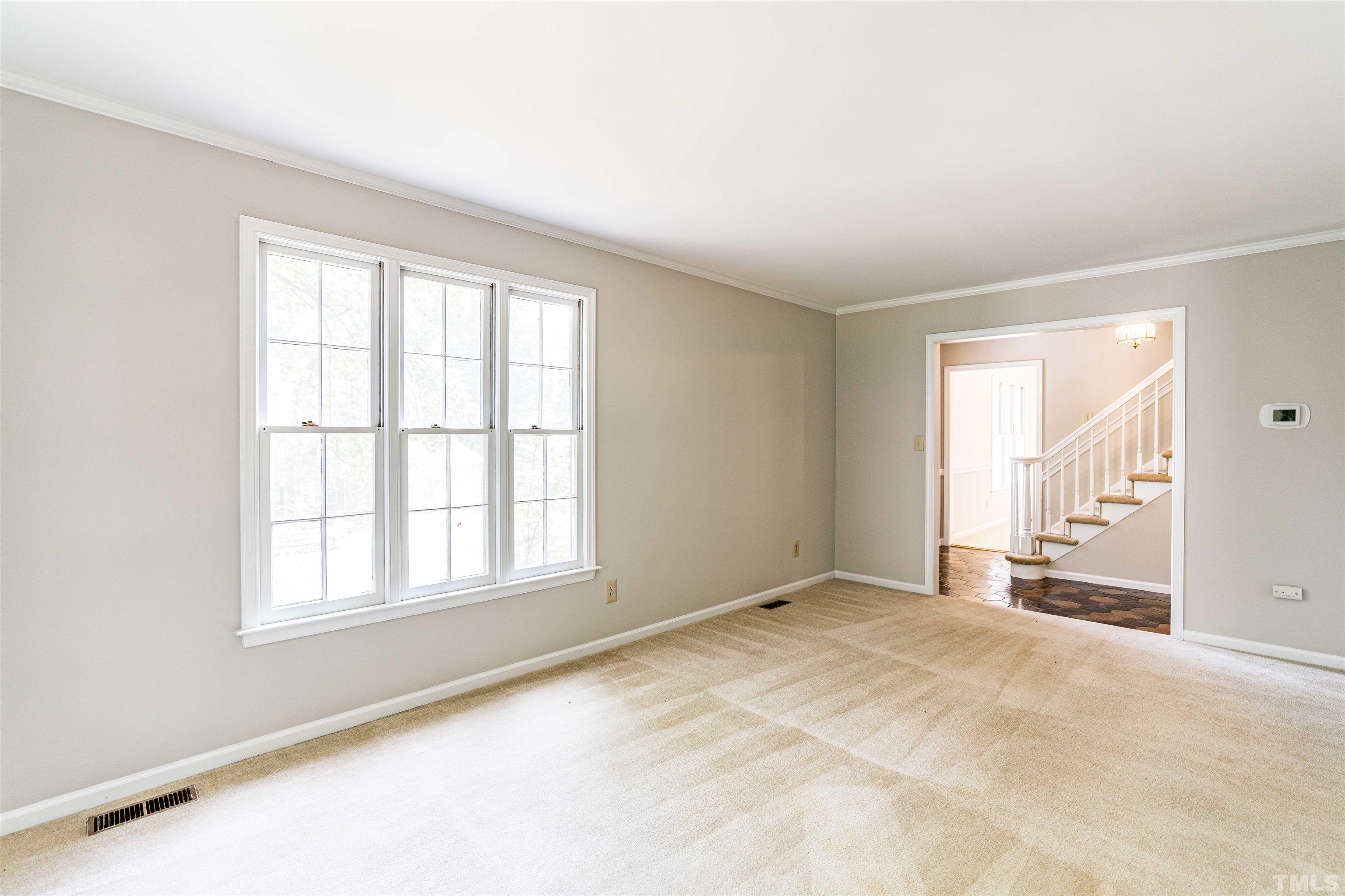 8645 Valley Brook Drive Raleigh, NC 27613 - Photo 6 of 32 an empty room with windows
