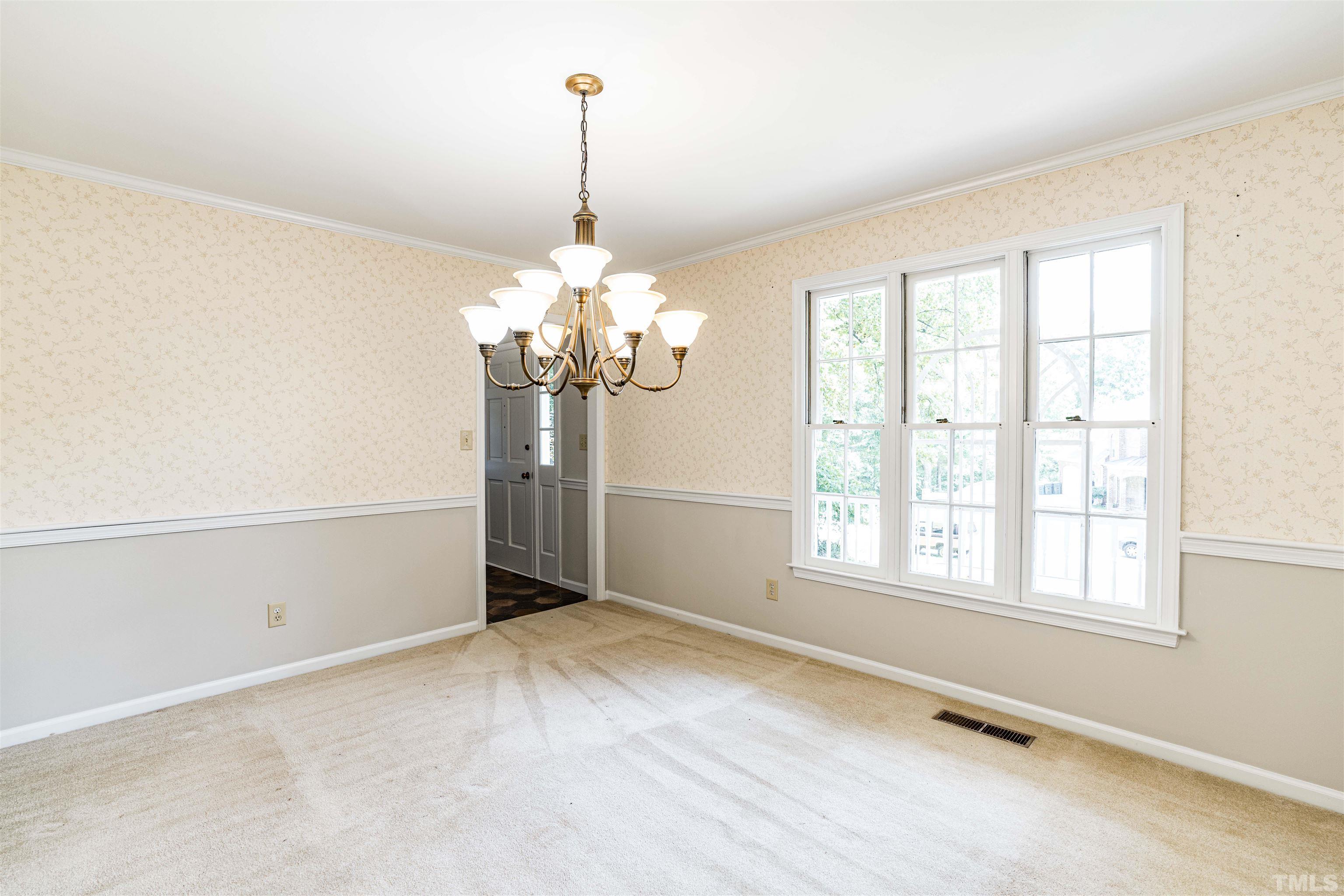8645 Valley Brook Drive Raleigh, NC 27613 - Photo 7 of 32 a view of a livingroom with a chandelier