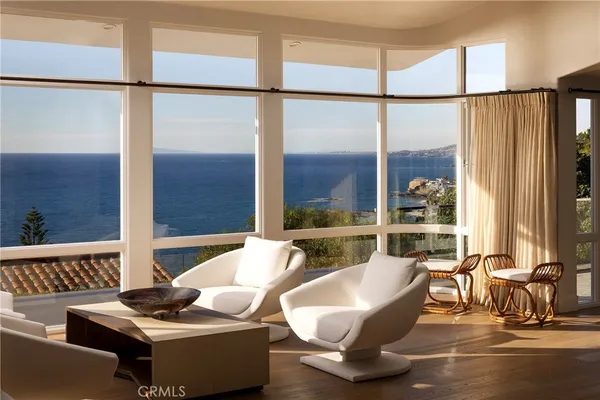 a living room with couches and a glass door with glass windows