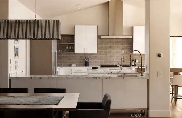 a kitchen with a table chairs and a refrigerator