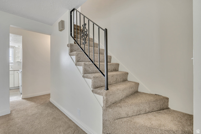 3166 Linden Street Bountiful, UT 84010 - Photo 5 of 25 Staircase with carpet floors and baseboards