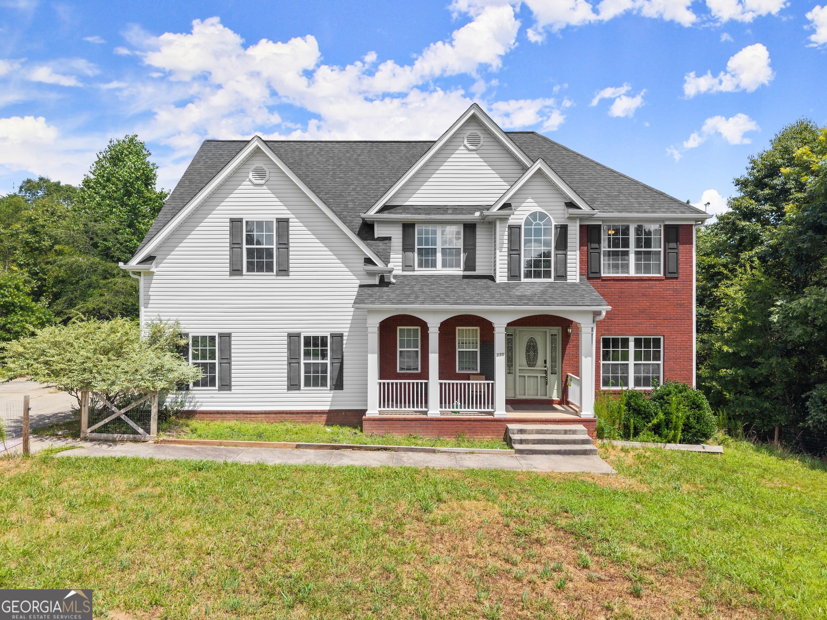 a front view of a house with garden