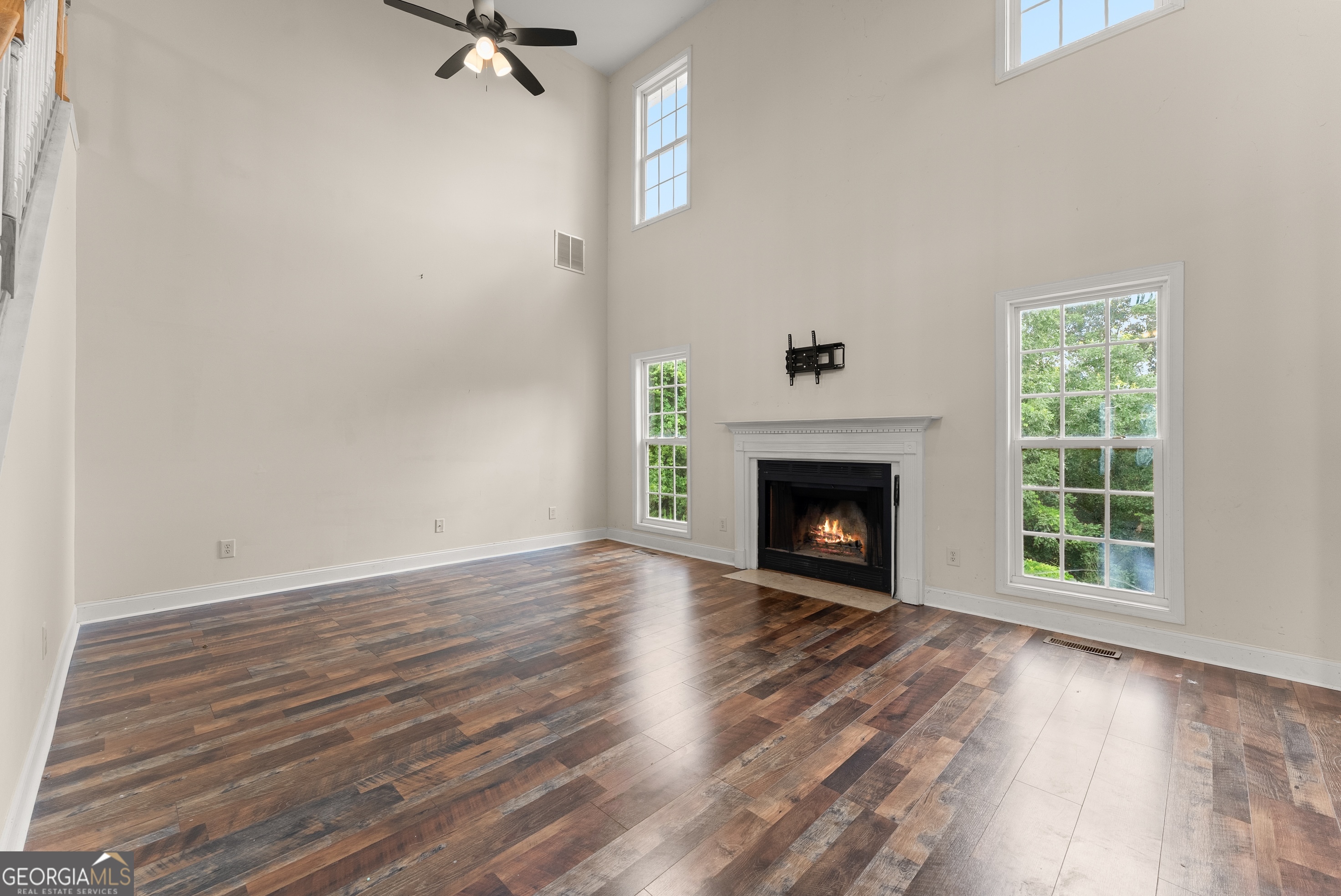 930 Heads Ferry Road Cornelia, GA 30531 - Photo 16 of 43 a view of an empty room with wooden floor fireplace and a window