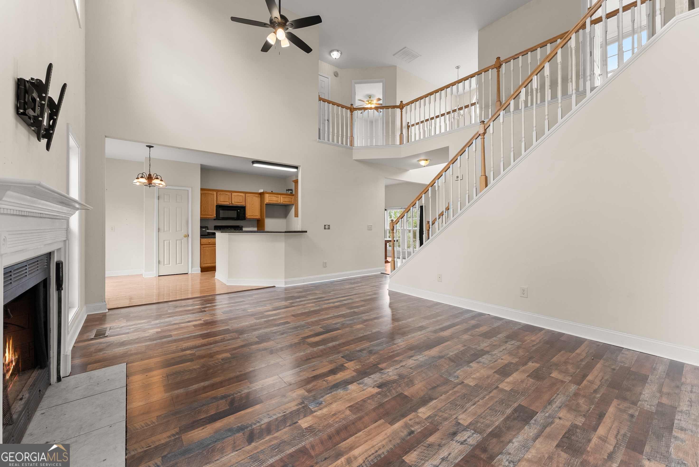 930 Heads Ferry Road Cornelia, GA 30531 - Photo 17 of 43 a view of an empty room with wooden floor and a fireplace