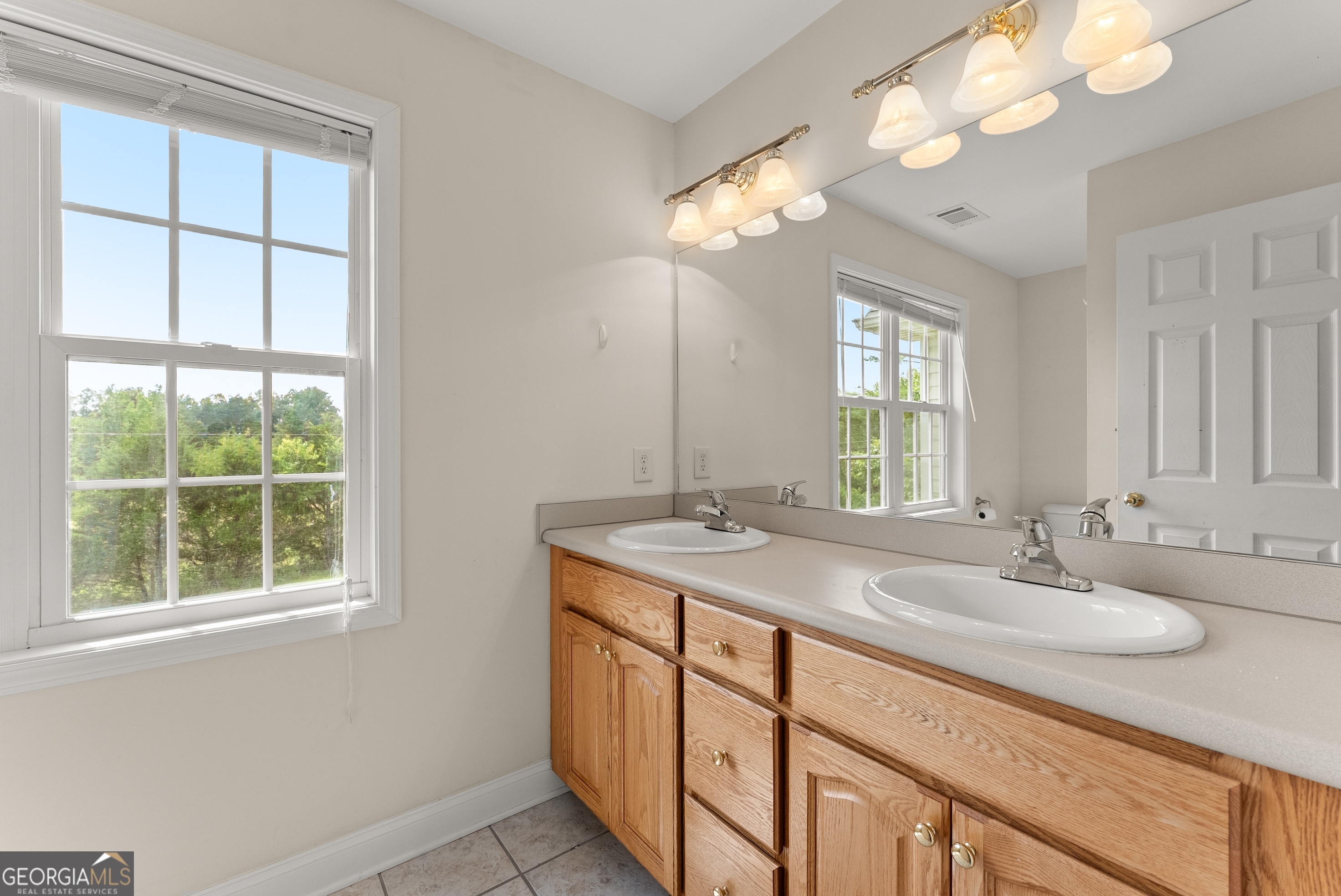 930 Heads Ferry Road Cornelia, GA 30531 - Photo 27 of 43 a bathroom with a sink double vanity and a mirror