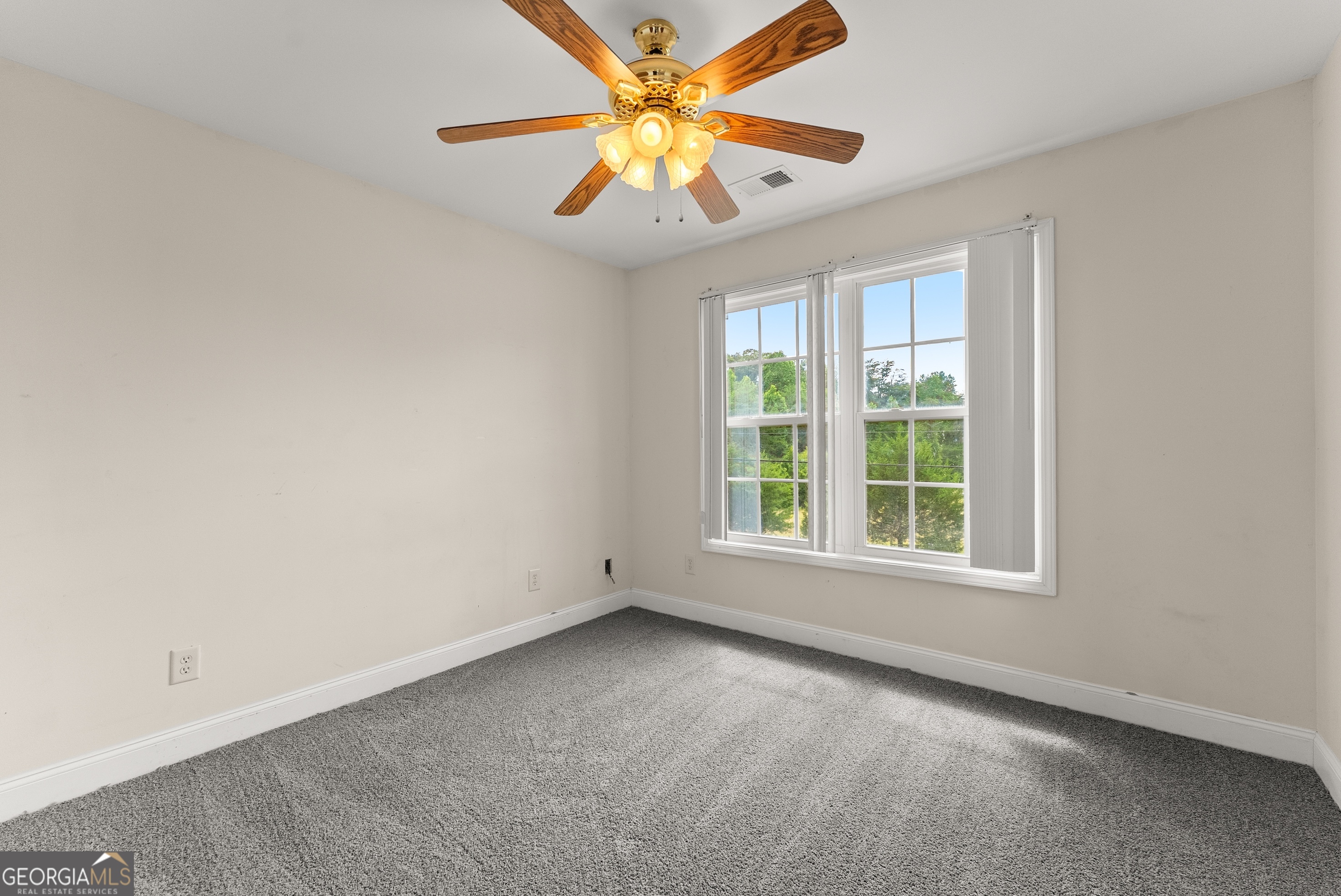 930 Heads Ferry Road Cornelia, GA 30531 - Photo 29 of 43 an empty room with windows and fan