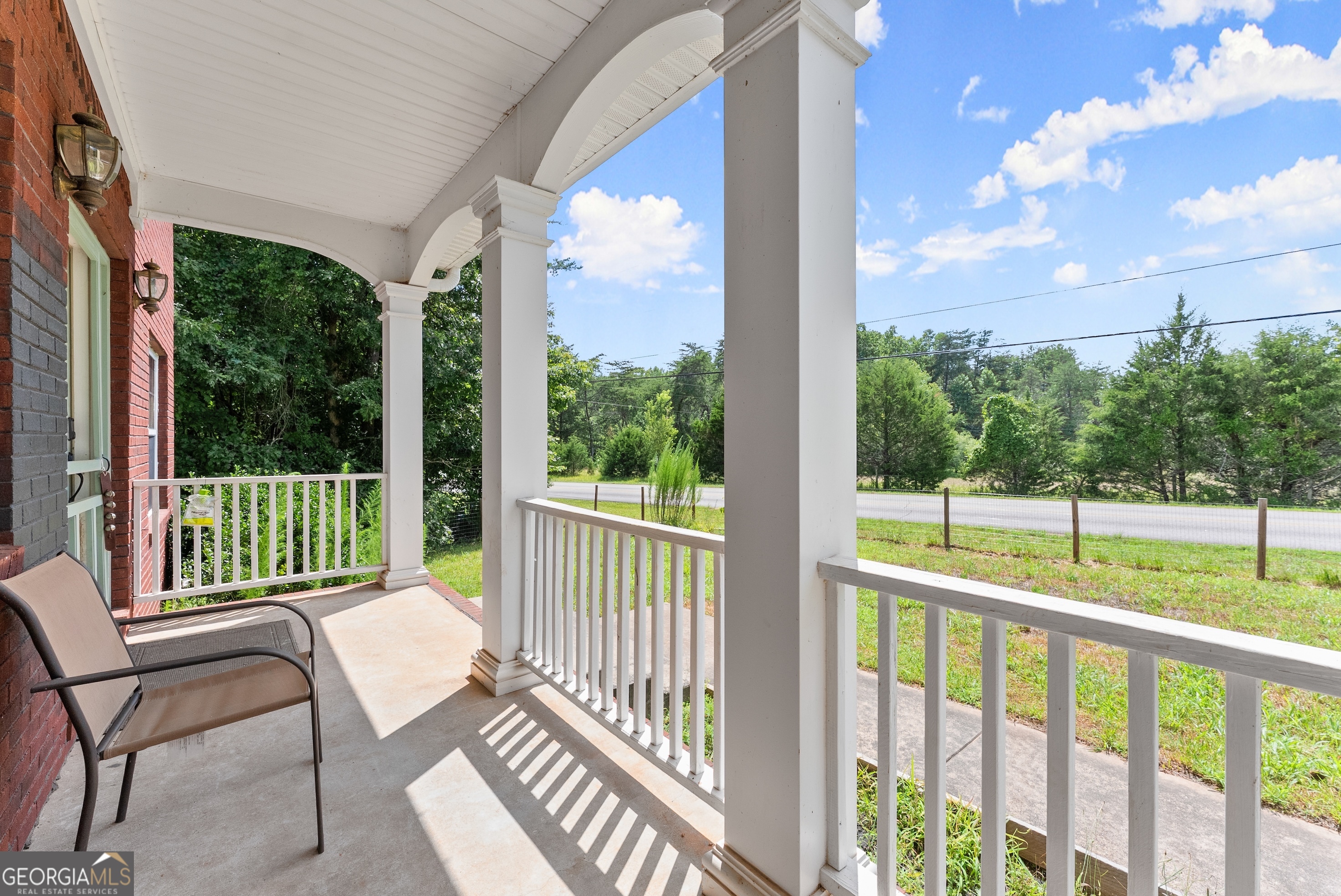 930 Heads Ferry Road Cornelia, GA 30531 - Photo 3 of 43 a view of a chair and tables in the balcony