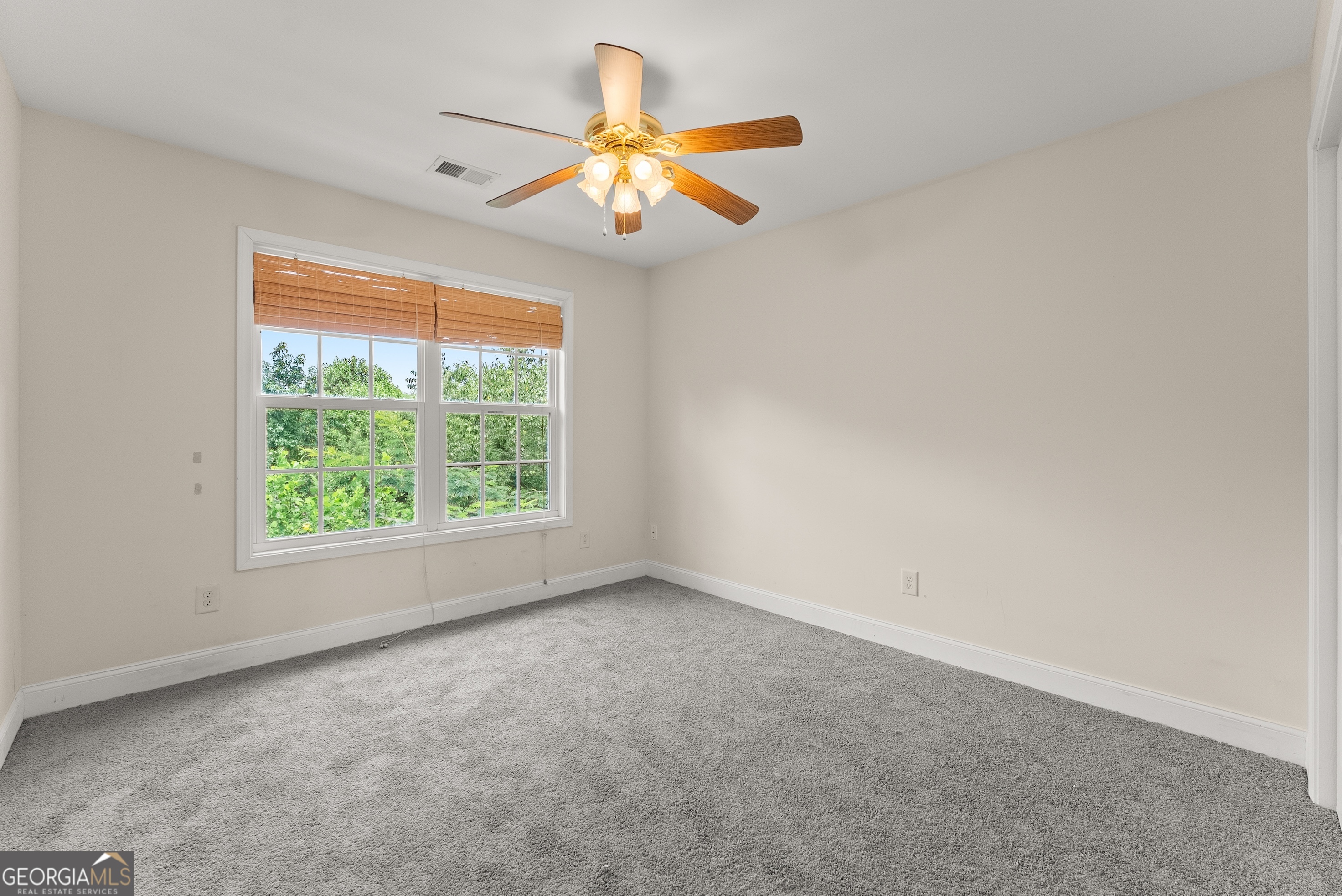 930 Heads Ferry Road Cornelia, GA 30531 - Photo 31 of 43 an empty room with a window and a fan