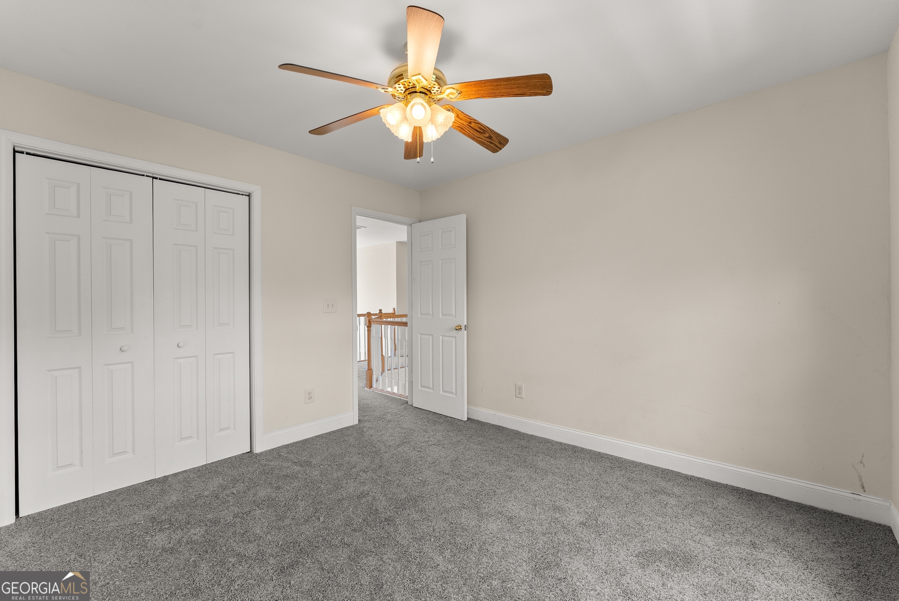 930 Heads Ferry Road Cornelia, GA 30531 - Photo 32 of 43 an empty room with closet and a chandelier fan