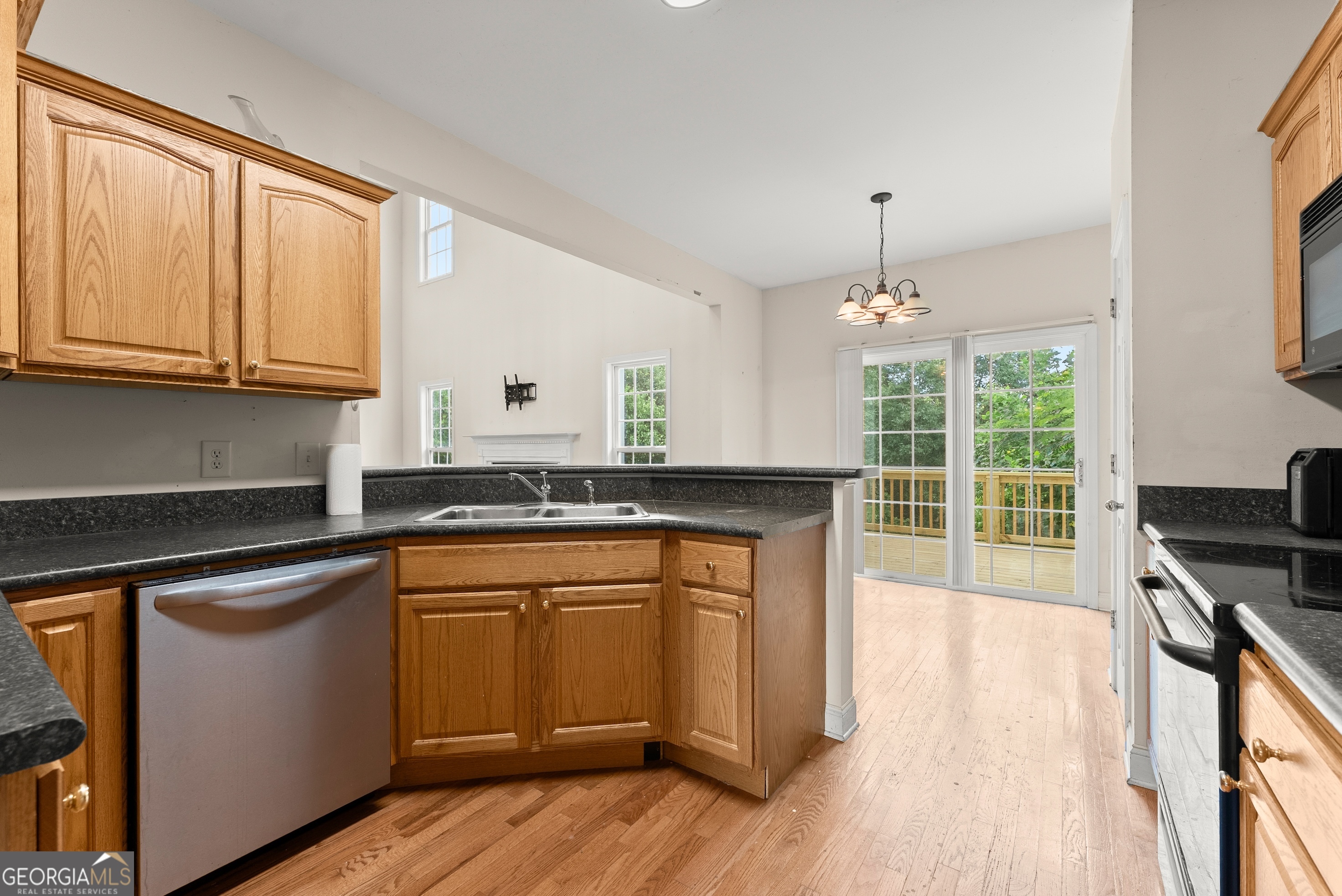 930 Heads Ferry Road Cornelia, GA 30531 - Photo 9 of 43 a kitchen with stainless steel appliances granite countertop a stove a sink dishwasher and a refrigerator with wooden floor