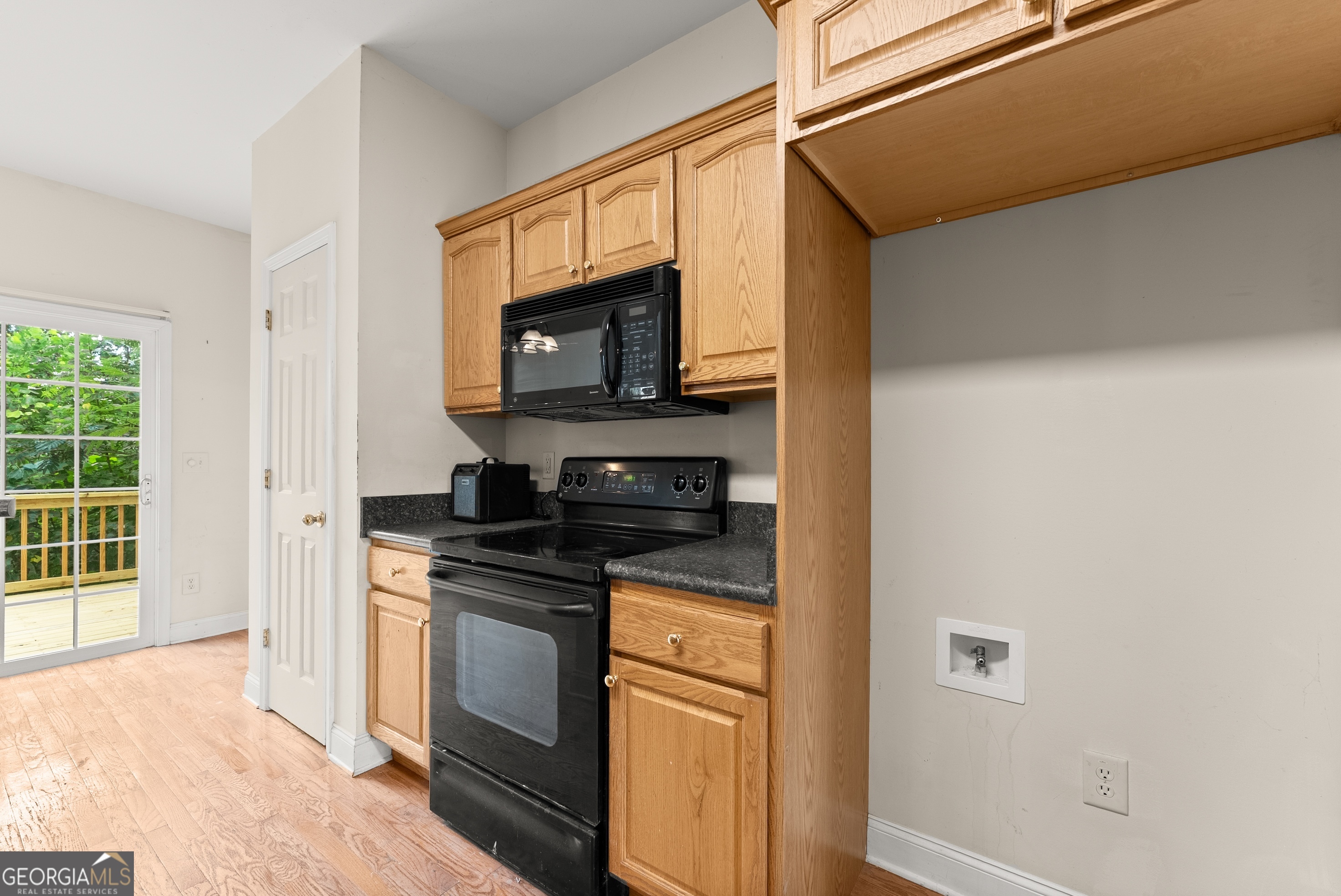 930 Heads Ferry Road Cornelia, GA 30531 - Photo 10 of 43 a kitchen with stainless steel appliances granite countertop a stove a microwave and a refrigerator