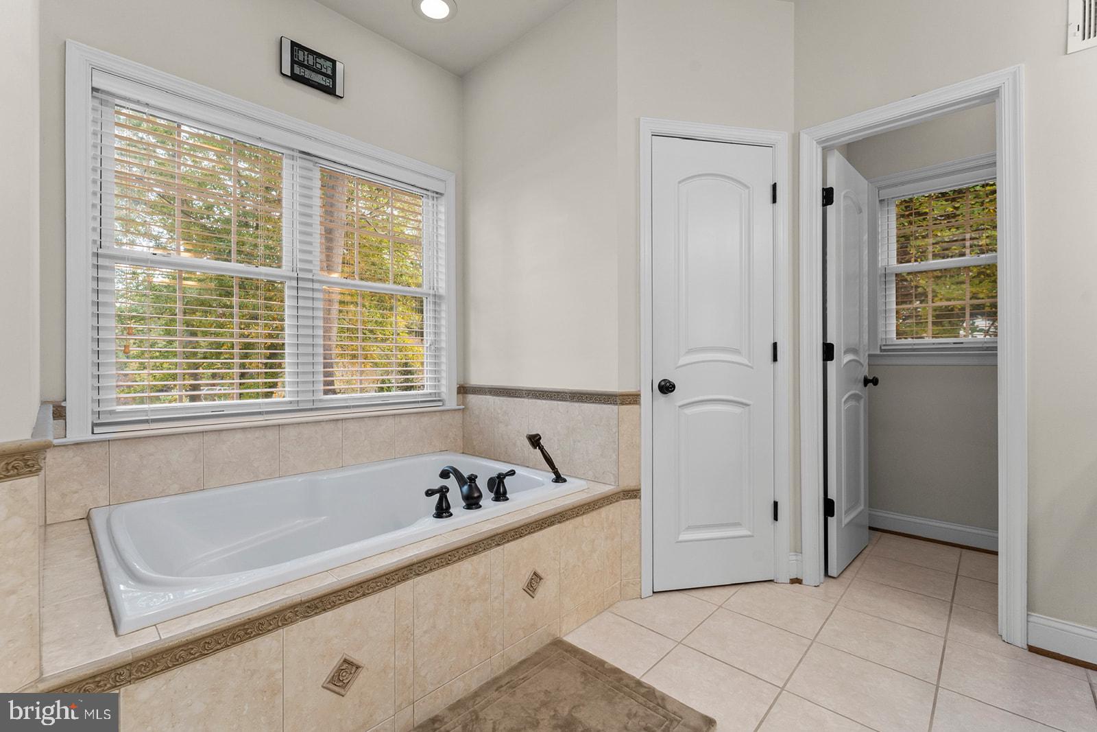 32 Dobe Point Road Stafford, VA 22554 - Photo 12 of 38 a spacious bathroom with a tub sink and mirror
