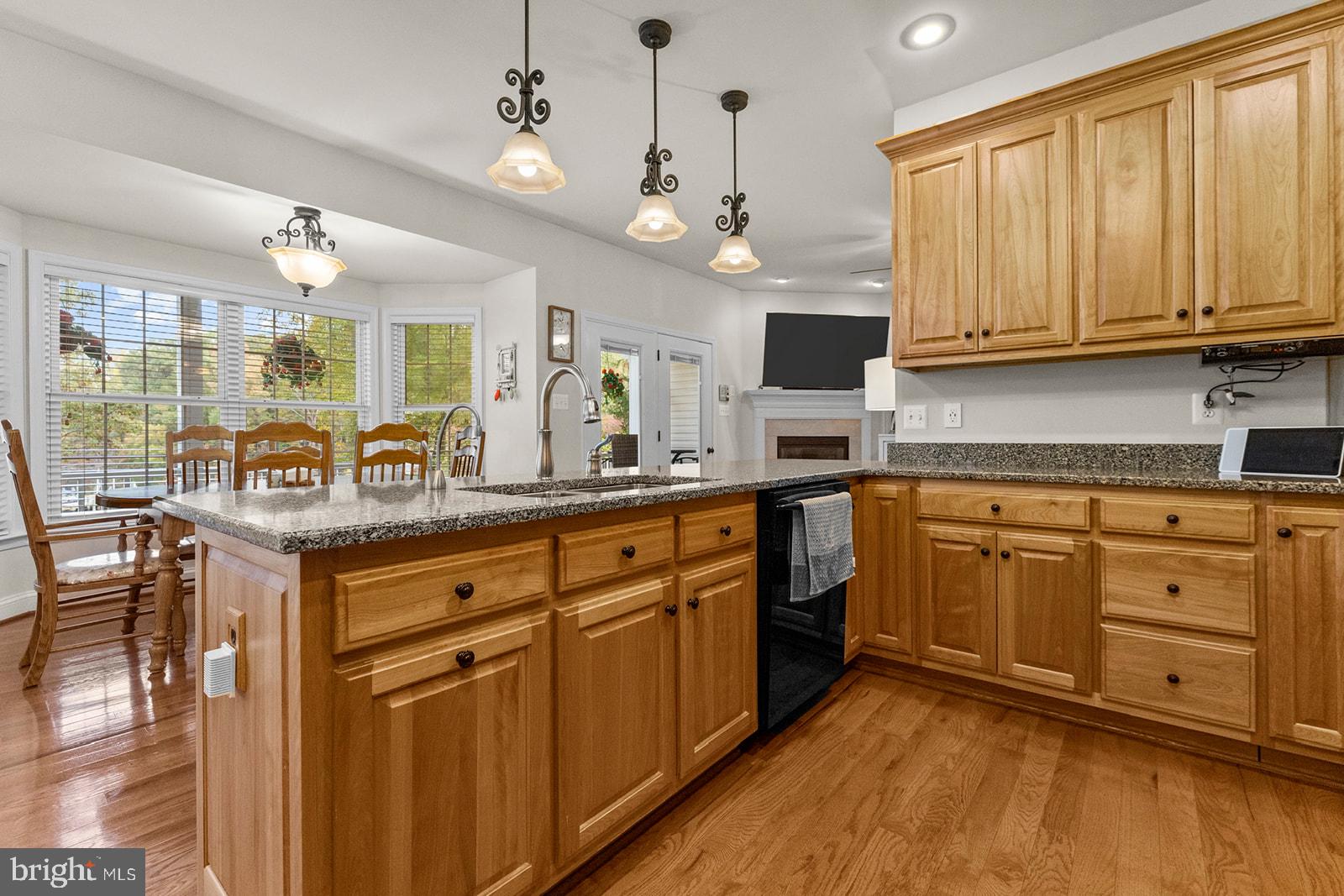 32 Dobe Point Road Stafford, VA 22554 - Photo 7 of 38 a kitchen with stainless steel appliances granite countertop a stove a sink dishwasher and white cabinets with wooden floor