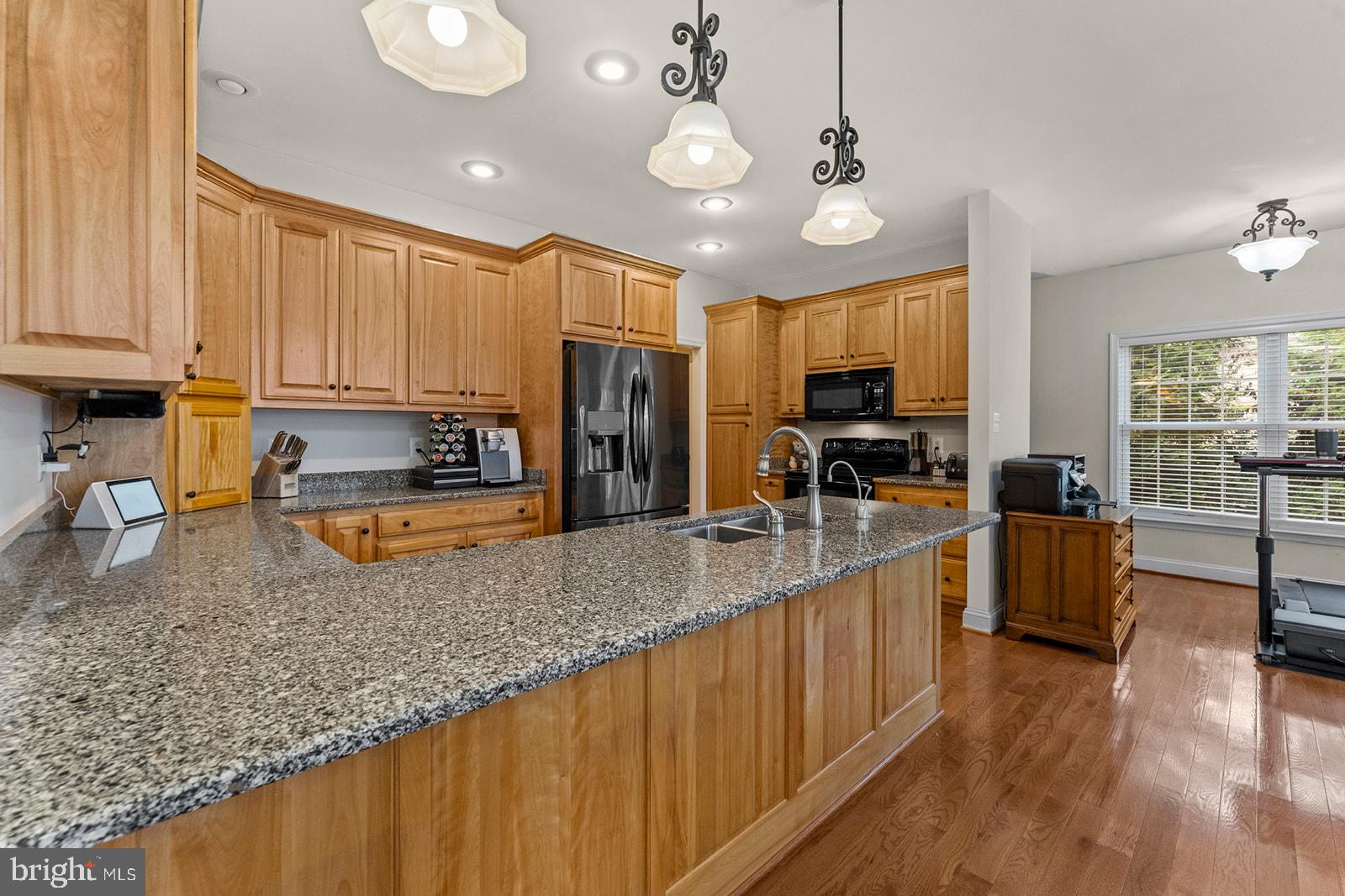 32 Dobe Point Road Stafford, VA 22554 - Photo 8 of 38 a kitchen with stainless steel appliances granite countertop wooden cabinets a refrigerator a stove a sink and dishwasher