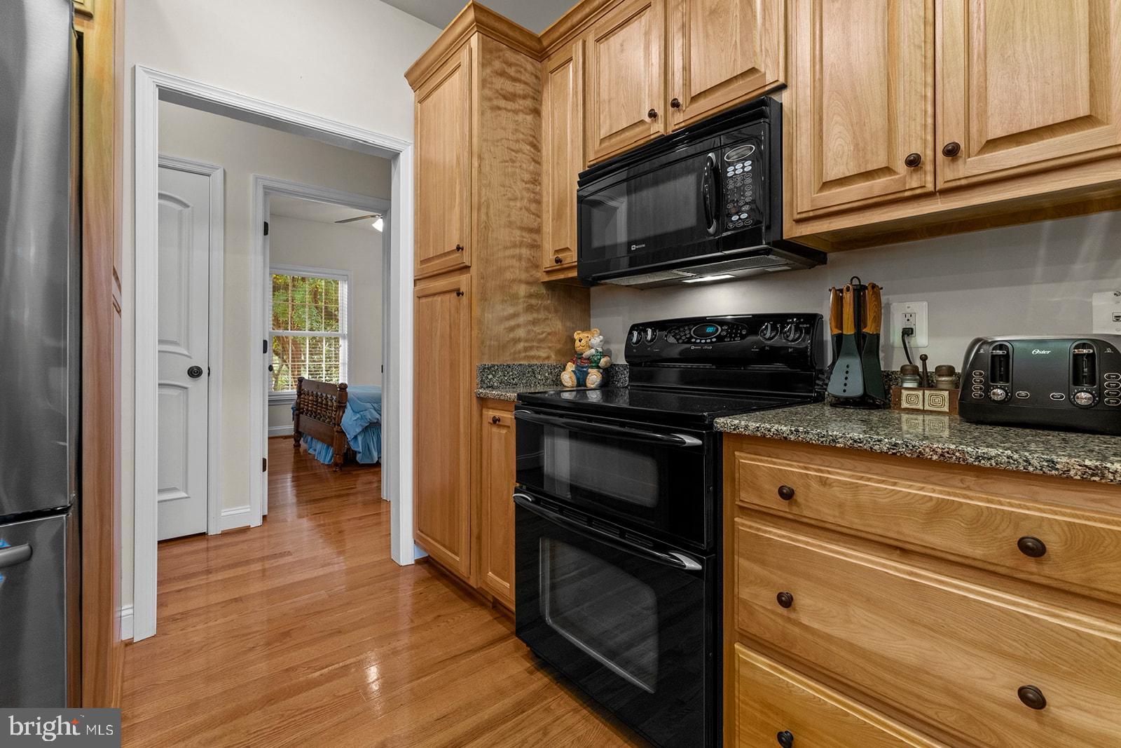 32 Dobe Point Road Stafford, VA 22554 - Photo 9 of 38 a kitchen with granite countertop cabinets stainless steel appliances and wooden floor