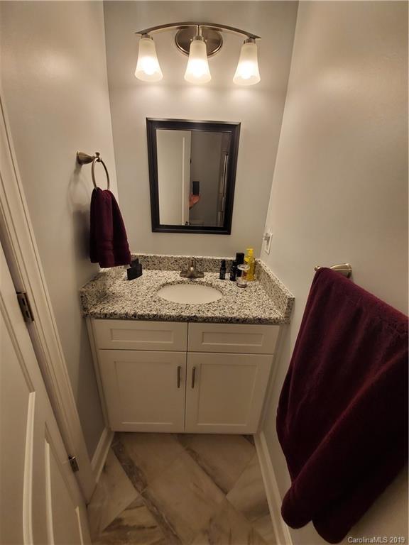 4501 Farmbrook Road Gastonia, NC 28056 - Photo 11 of 23 a bathroom with a granite countertop sink a vanity and mirror