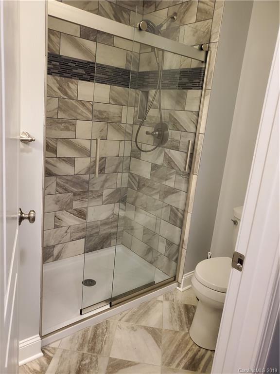 4501 Farmbrook Road Gastonia, NC 28056 - Photo 12 of 23 a bathroom with a shower and a toilet