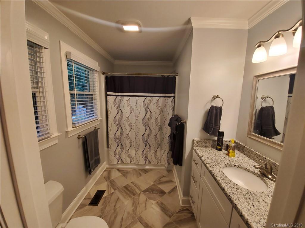 4501 Farmbrook Road Gastonia, NC 28056 - Photo 16 of 23 a bathroom with a tub sink and mirror