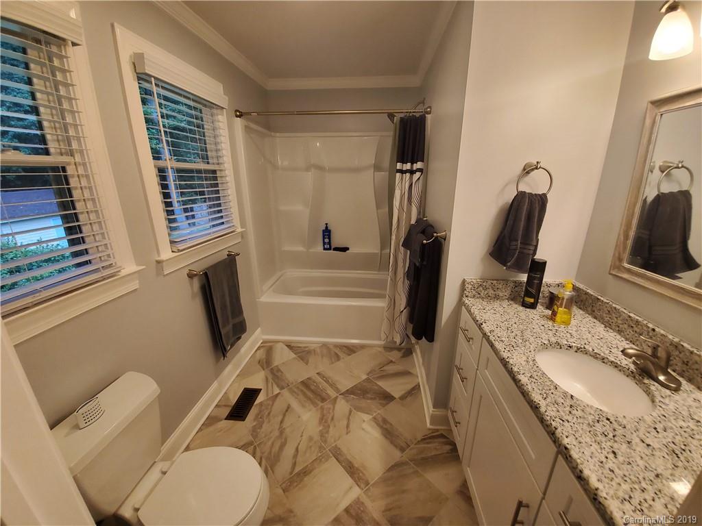 4501 Farmbrook Road Gastonia, NC 28056 - Photo 17 of 23 a bathroom with a granite countertop sink mirror vanity and toilet