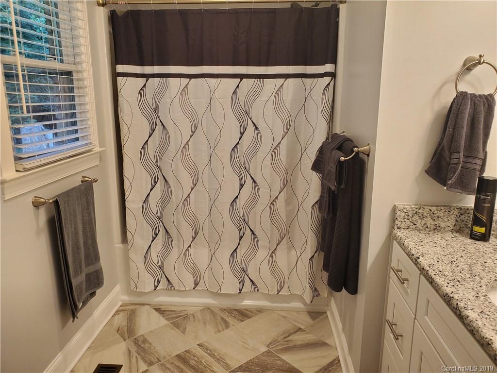 4501 Farmbrook Road Gastonia, NC 28056 - Photo 18 of 23 a bathroom with a granite countertop sink and a mirror