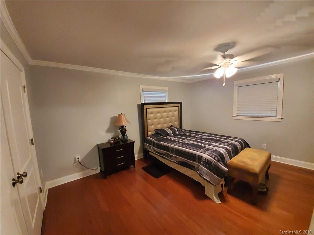 4501 Farmbrook Road Gastonia, NC 28056 - Photo 19 of 23 a bedroom with a bed and wooden floor
