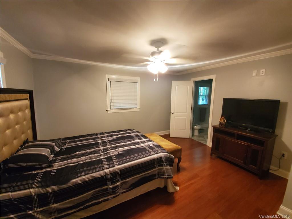 4501 Farmbrook Road Gastonia, NC 28056 - Photo 20 of 23 a bedroom with a bed and a flat screen tv