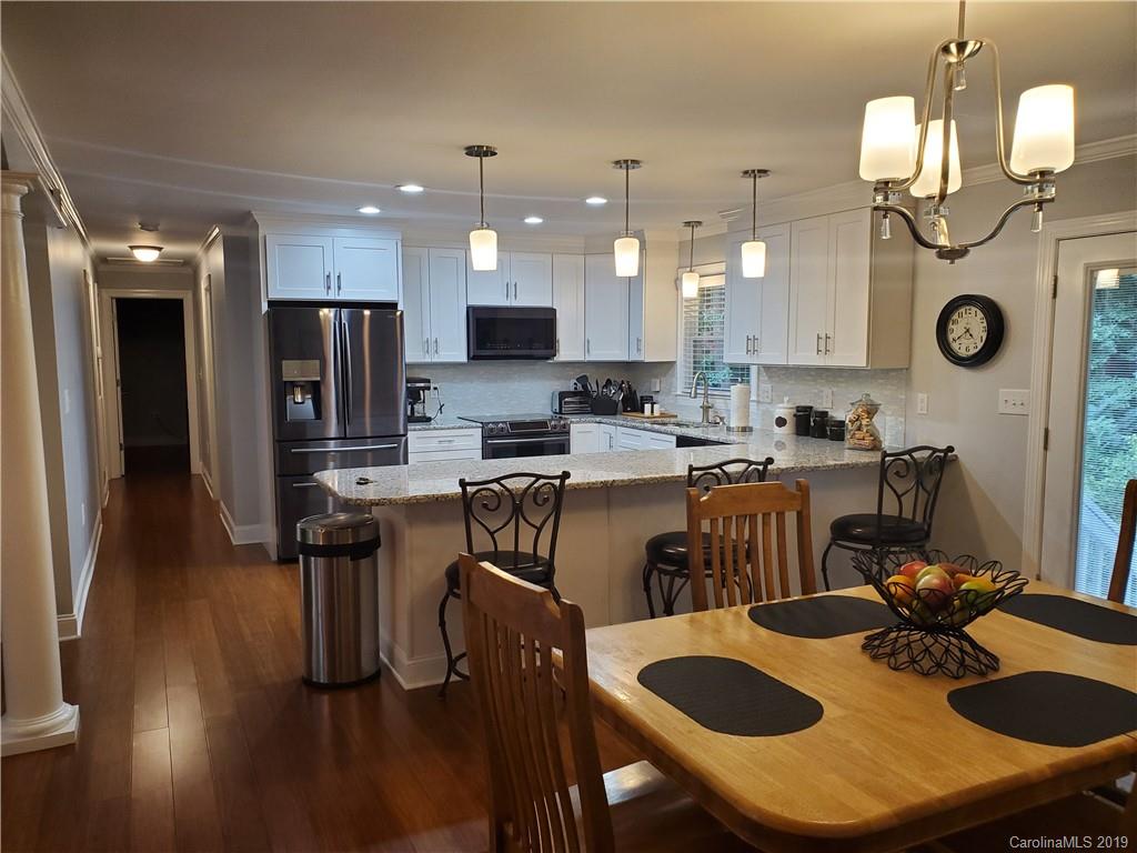 4501 Farmbrook Road Gastonia, NC 28056 - Photo 4 of 23 a kitchen with kitchen island appliances and wooden floor