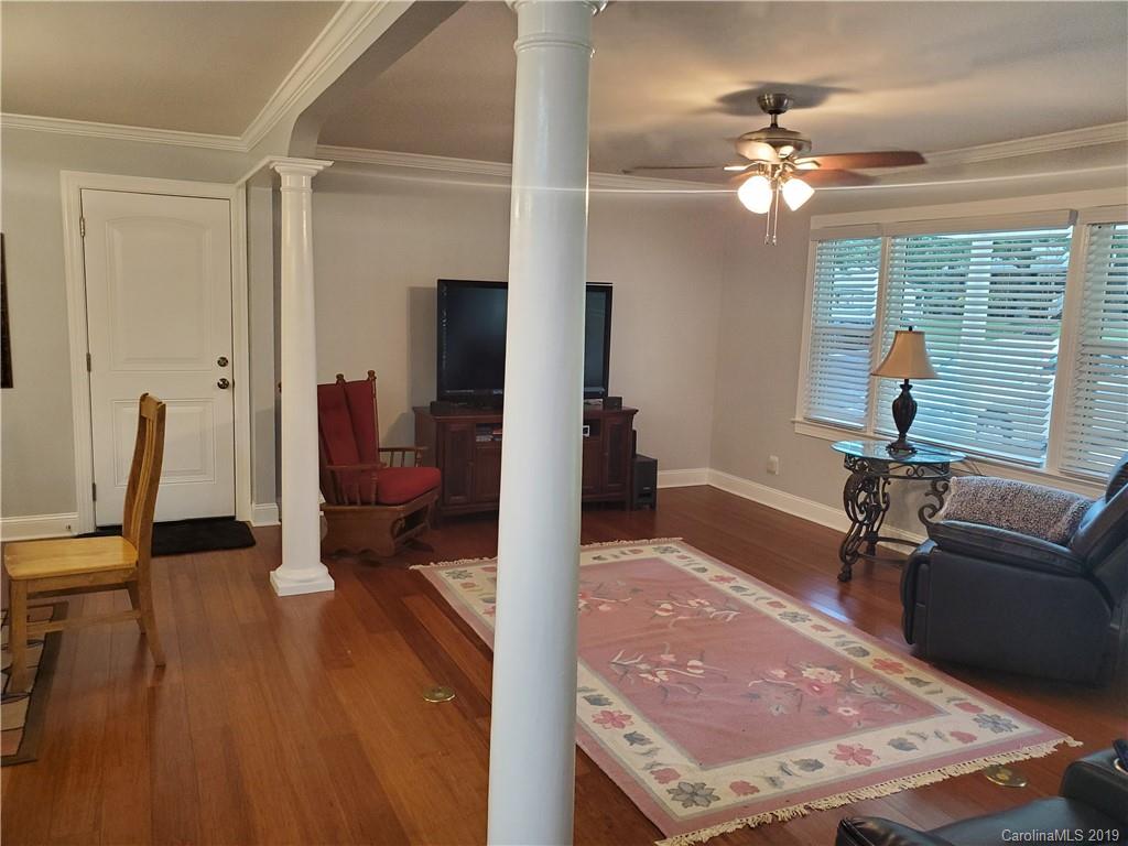 4501 Farmbrook Road Gastonia, NC 28056 - Photo 10 of 23 a living room with furniture a dining table and a chandelier
