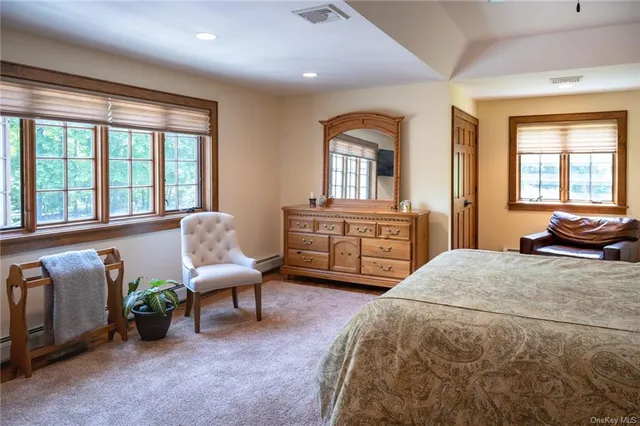a spacious bathroom with a granite countertop tub sink and mirror