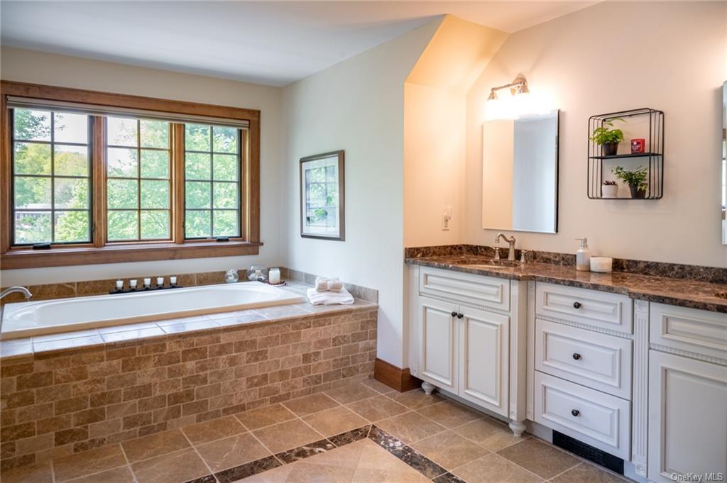 15 Sickletown Road Pearl River, NY 10965 - Photo 20 of 35 a spacious bathroom with a granite countertop tub sink and mirror