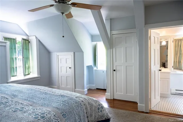 a bed sitting in a bedroom next to a window