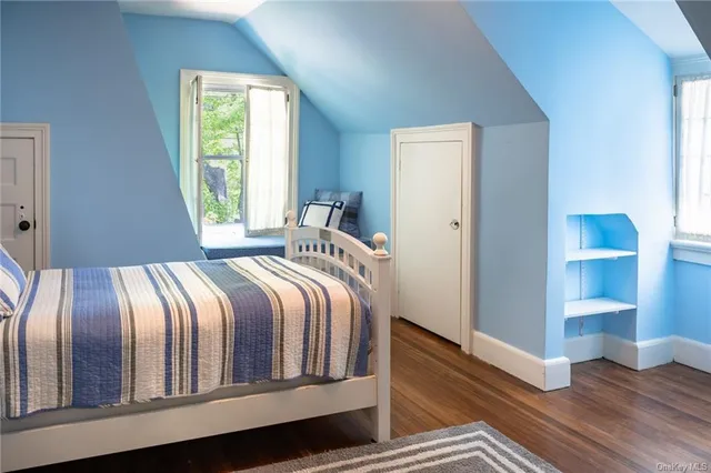 a bedroom with a bed and a window