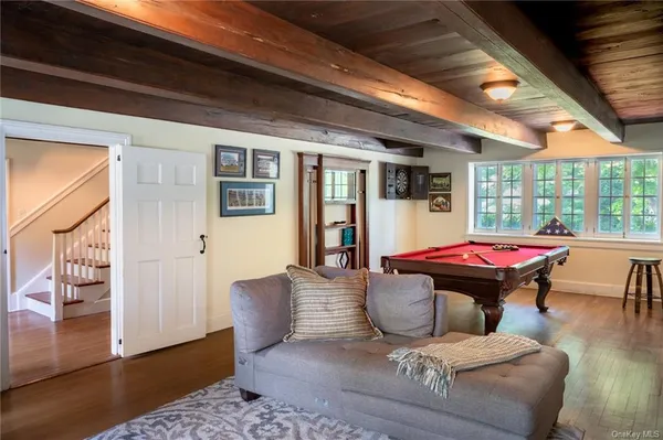 a dining room with furniture a fireplace and wooden floor