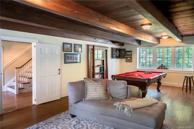 a dining room with furniture a fireplace and wooden floor