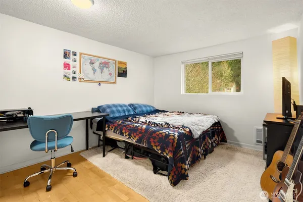 a bedroom with a bed and a desk