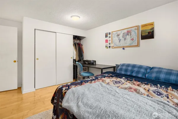 a bed sitting in a bedroom next to a window