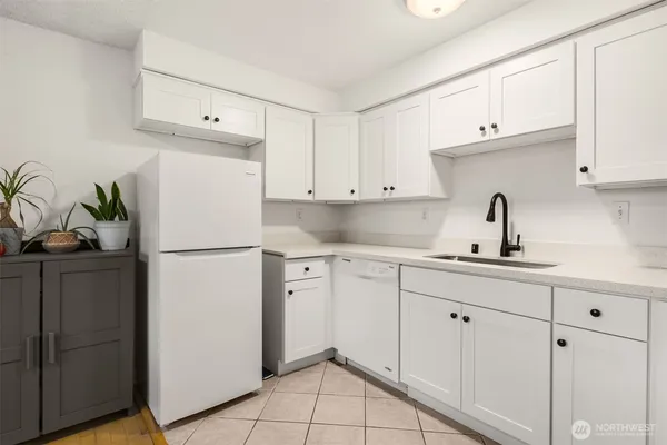 a kitchen with appliances a sink and cabinets