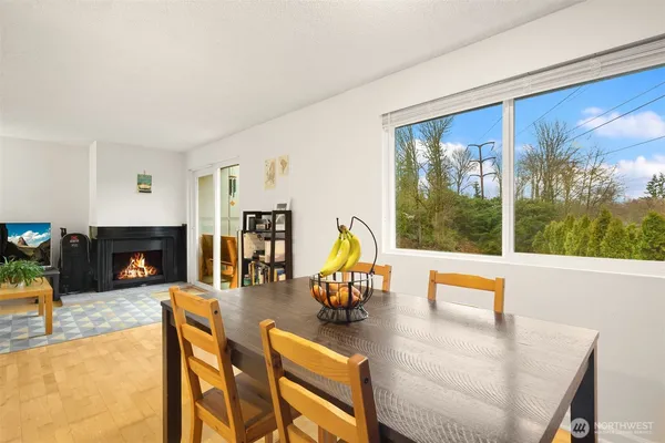 a living room with fireplace furniture and a large window