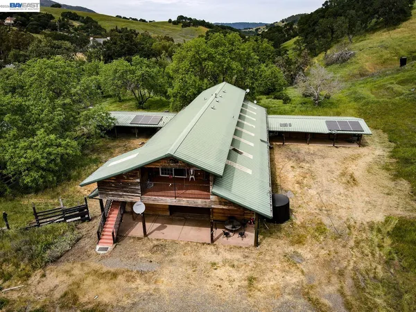 an aerial view of a house with a yard and trees