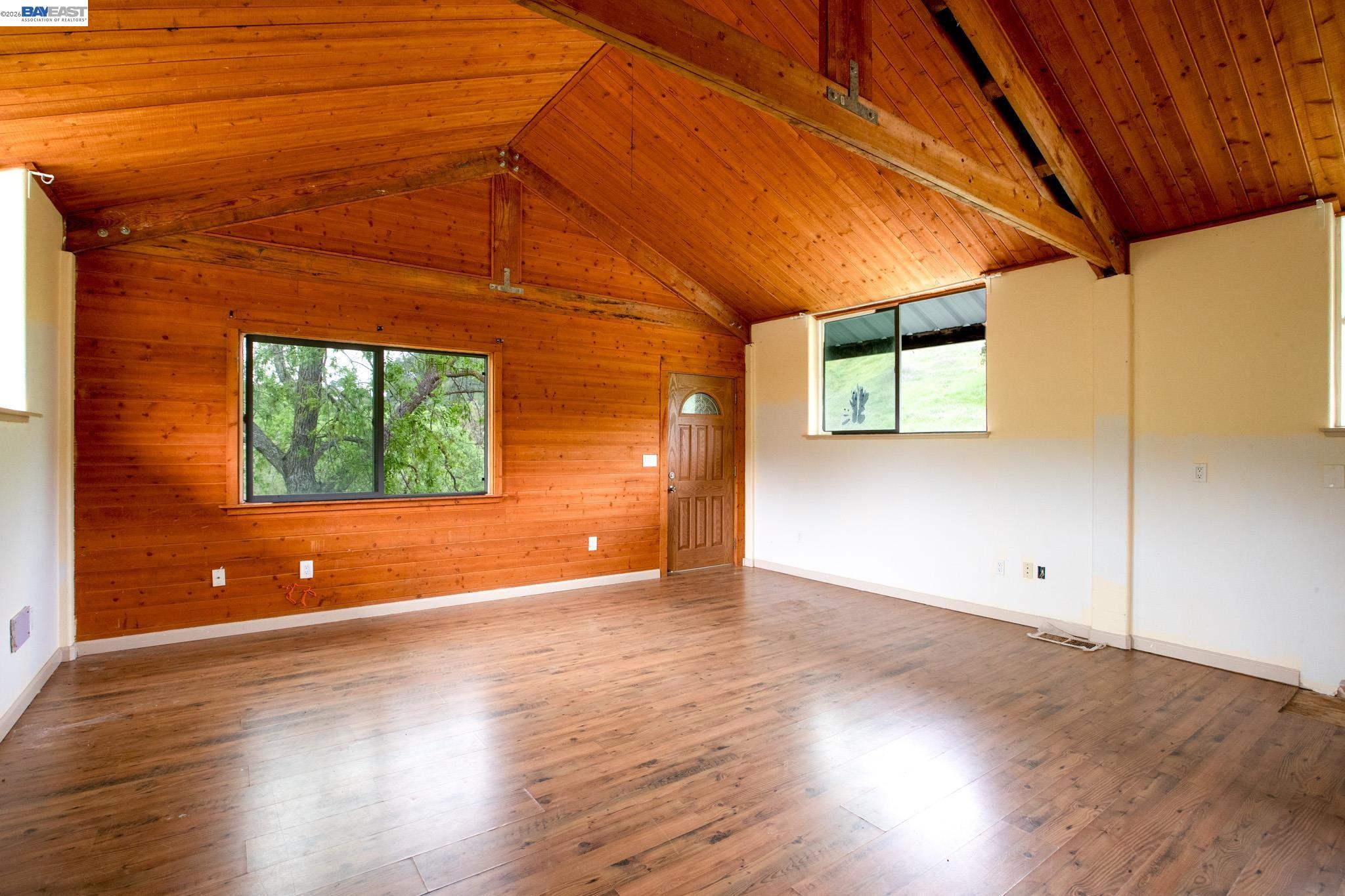 6115 Morgan Territory Road Clayton, CA 94517 - Photo 15 of 60 an empty room with wooden floor and windows