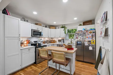 a kitchen with refrigerator and cabinets