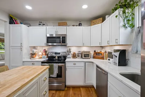 a kitchen with a sink cabinets and window