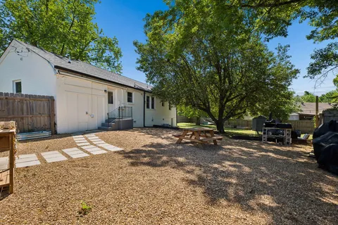 a view of a backyard with swimming pool