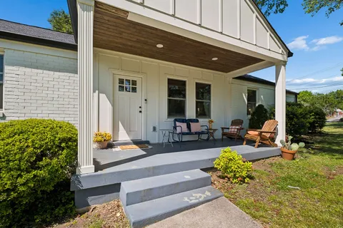 a building outdoor space with patio furniture and potted plants