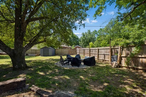 a view of house with backyard