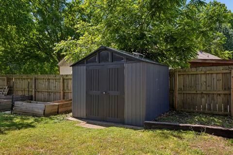 a front view of a house with a yard garage and outdoor seating