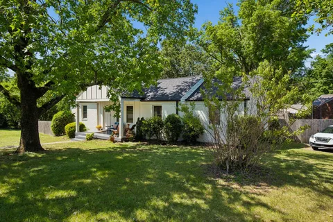 a view of a house with backyard sitting area and garden