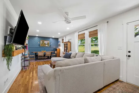a living room with furniture and a flat screen tv