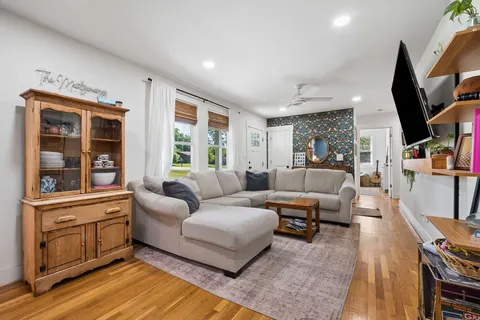 a living room with furniture and a flat screen tv