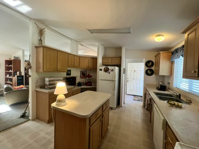 a kitchen with a refrigerator a stove and a sink